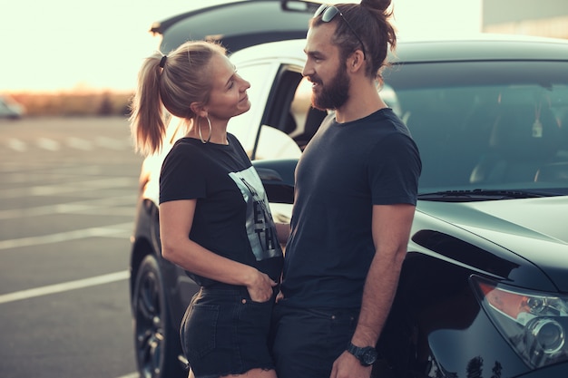 Encantadora pareja feliz divertirse juntos en el lugar de estacionamiento