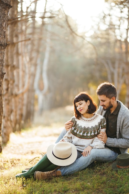 Encantadora pareja hipster mirándose Pareja con hermosos sombreros y suéteres