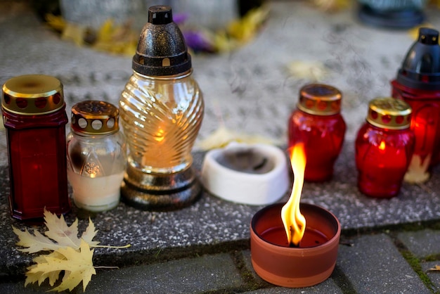 Foto se enciende una vela junto a un candelabro rojo.