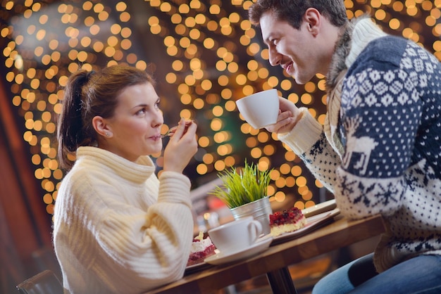 encontro romântico à noite no restaurante feliz casal jovem com copo de vinho, chá e bolo