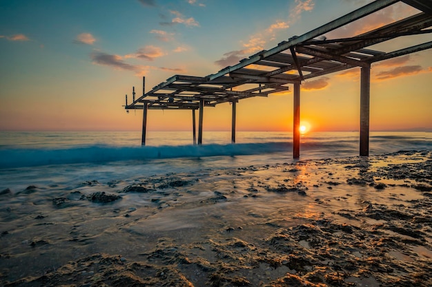 encuentro de muelle y mar con puesta de sol