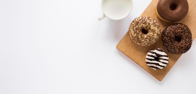 Endecha plana de donas con leche y espacio de copia