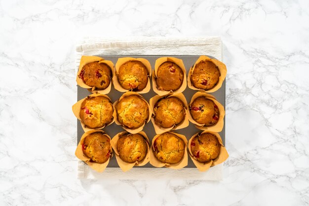 Endecha plana. Muffins de arándanos recién horneados en moldes para muffins de papel marrón.