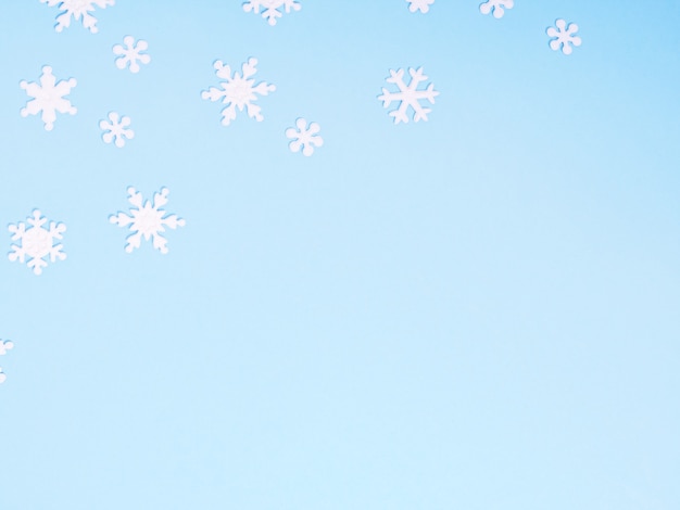 Enfeite de Natal com flocos de neve sobre fundo azul.