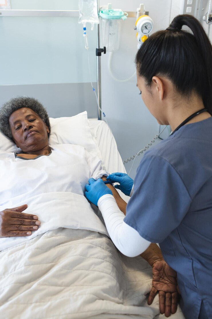 Foto enfermeira cuida de uma mulher afro-americana idosa em uma cama de hospital