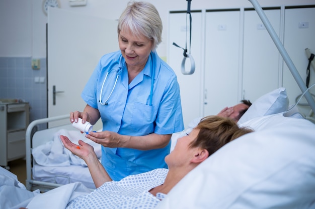 Enfermeira dando medicação ao paciente