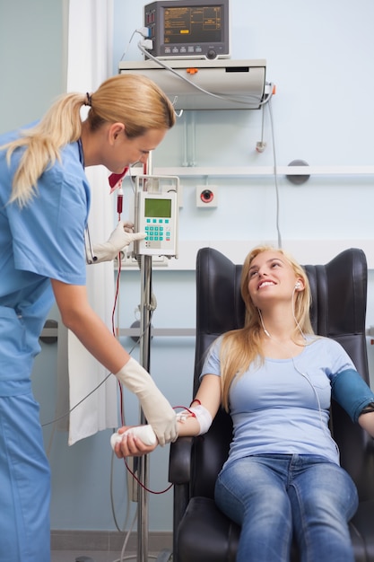 Enfermeira tomando o pulso de um doador de sangue