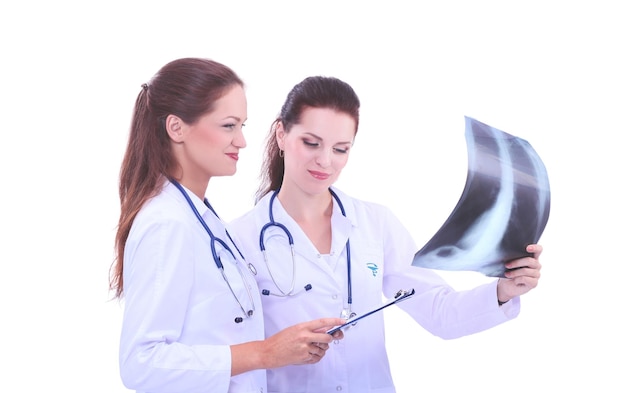 Enfermera de dos mujeres viendo la imagen de rayos X de pie en el hospital