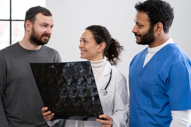 Foto enfermera y médico hablando con el paciente