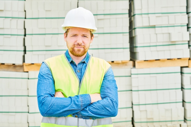 Engenheiro confiante perto de materiais de construção