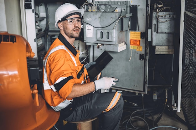 Engenheiro de eletricidade masculino, trabalho perigoso, serviço de reparo, trabalhador de armário elétrico de alta tensão, problema de problema de surto elétrico na fábrica da indústria