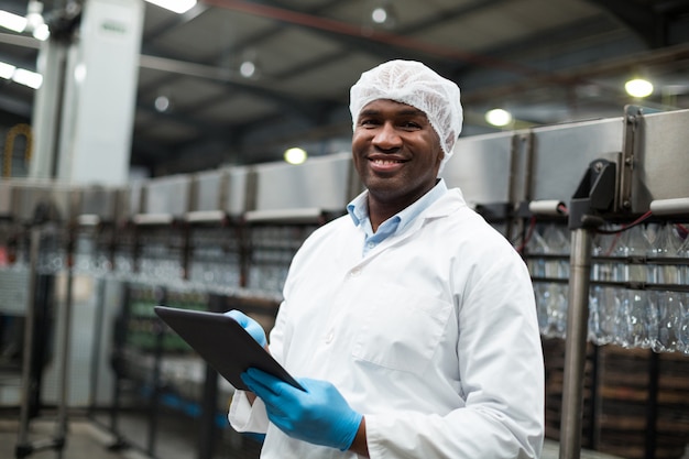 Engenheiro de fábrica usando tablet digital na fábrica