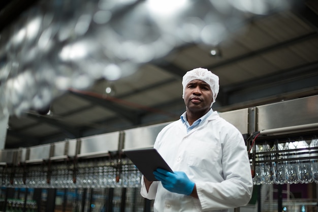 Engenheiro de fábrica usando tablet digital na fábrica