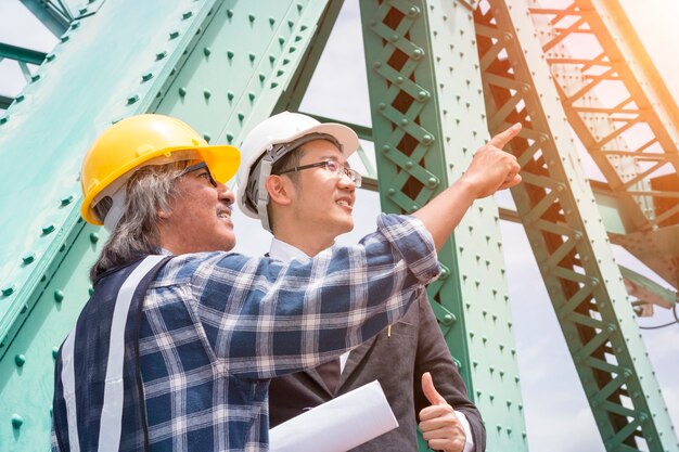 Engenheiro de negócios de manjedoura sorrindo e tomando sobre o trabalho de sucesso com os parceiros.