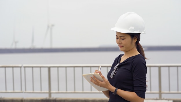 Engenheiro feminino asiático, verificando o trabalho