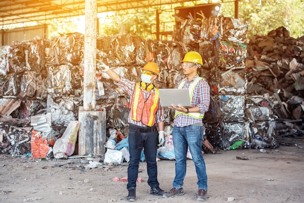 Engenheiro mecânico industrial profissional com trabalhador de fábrica enquanto usa o computador portátil na fábrica de fabricação industrial de torno de metal.