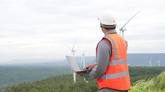 Engenheiro trabalhando em um parque eólico no topo de uma colina ou montanha na zona rural Ideal progressivo para a produção futura de energia renovável sustentável Geração de energia a partir de turbinas eólicas