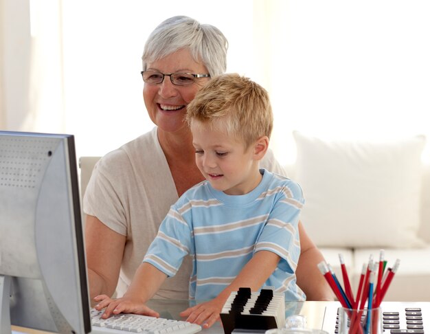 Enkel und Großmutter, die einen Computer verwenden
