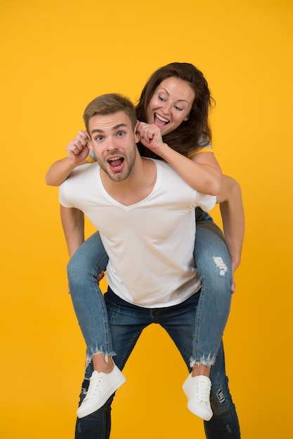 Enlouquecendo juntos. Humor louco de mulher e homem bonito. Casal louco apaixonado se divertindo. Sentindo-se livre e louco. Jovens. Tempo para a família. Namorada pegando carona. Humor alegre. Emoções positivas.