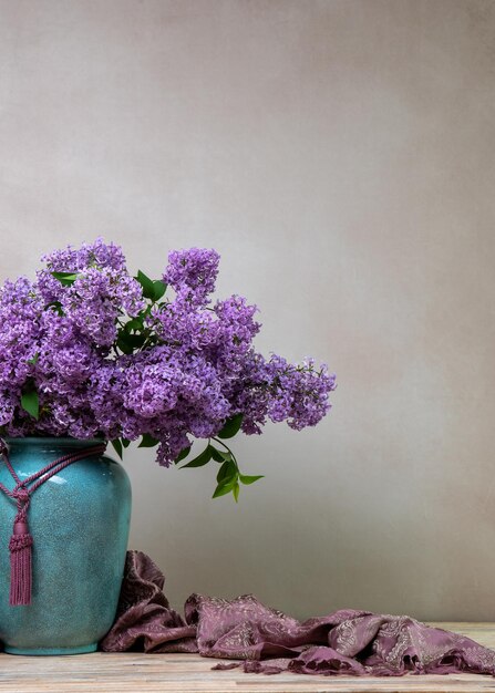 Un enorme ramo de lilas en un gran jarrón aislado en un fondo claro naturaleza muerta con flores mucho espacio para el texto