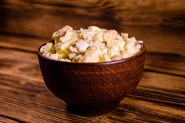 Ensalada de alubias y carne aliñada con mayonesa en cuenco de cerámica