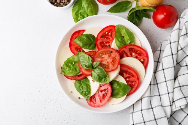 Foto ensalada caprese hecha de tomates frescos en rodajas queso mozzarella y albahaca