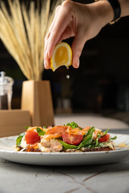 Ensalada con cerezas de hierbas de caviar de salmón sobre una mesa de piedra blanca en un restaurante