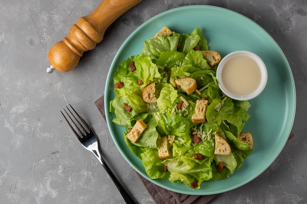 Ensalada César con picatostes y tocino.