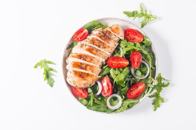 Ensalada con filete de pollo a la plancha, verduras frescas, espinacas, rúcula, cebolla morada y tomate.