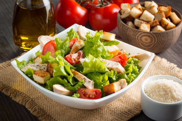 Foto ensalada fresca con deliciosa pechuga de pollo, ruccola, espinacas, repollo, rúcula y tomate