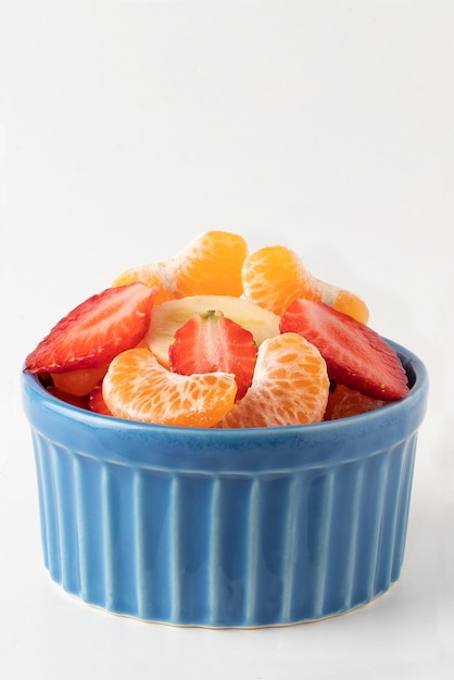 Ensalada de frutas saludables en un fondo blanco.