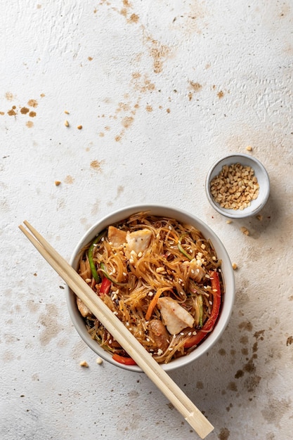 Ensalada funchose asiática con pollo y verduras en un tazón con espacio para copiar Menú de comida Vista superior