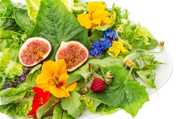 Ensalada de hojas verdes con higos y flores comestibles del jardín. Nutrición de desintoxicación de alimentos saludables