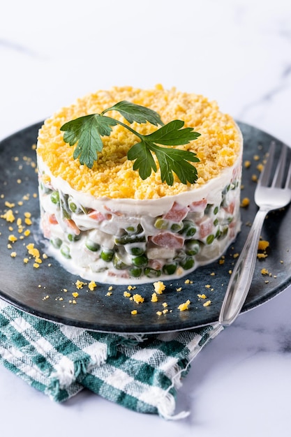 Ensalada rusa o ensalada Olivier para la cena de Navidad sobre fondo de mármol