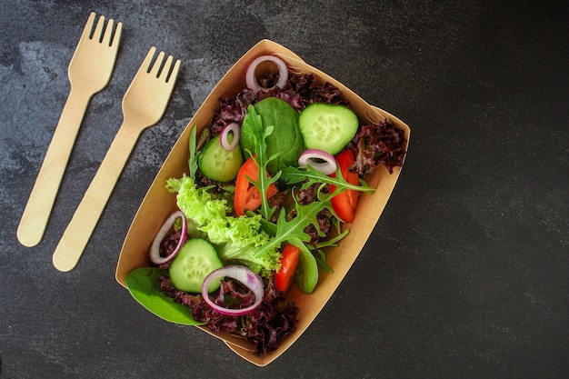 Ensalada saludable, ensalada de hojas en vajilla desechable de papel