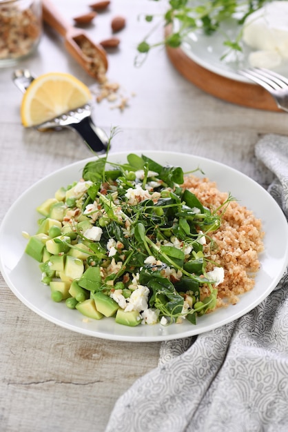 Ensalada verde sin gluten a base de microverdes, guisantes, aguacate, quinoa, espinacas