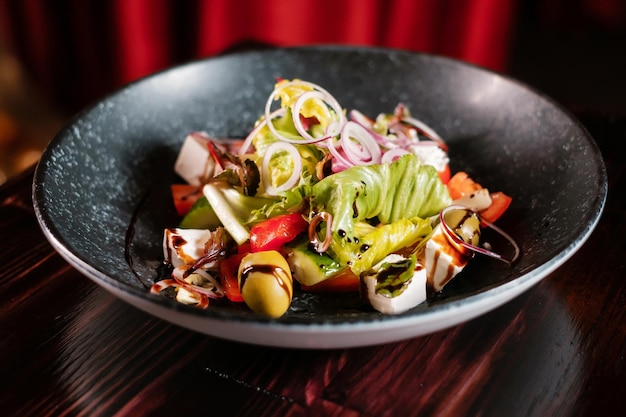 Ensalada de verduras con aceitunas cebollas hierbas y queso