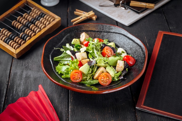 Ensalada de verduras frescas en un plato negro