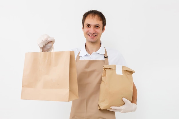 entregador trabalhando em camisa com avental e luvas de proteção mão segurando um pacote isolado com fundo branco