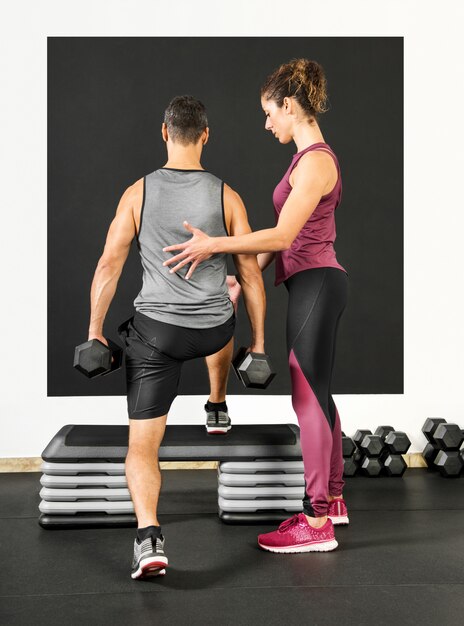 Foto entrenador personal femenino en un gimnasio