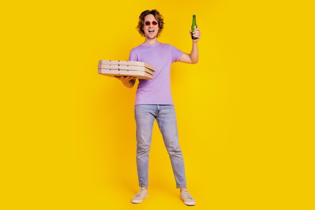Entspannt positiv sorglos lustiger Kerl halten Bierflasche Pizzakarton Haufen tragen lässiges Outfit Party vorbereiten