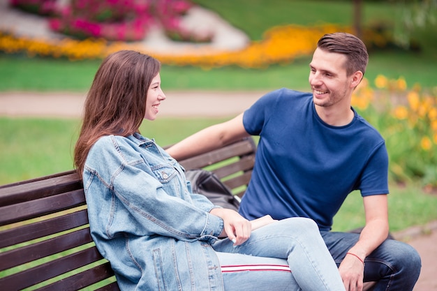 Entspannte junge Familie auf der Bank im Park