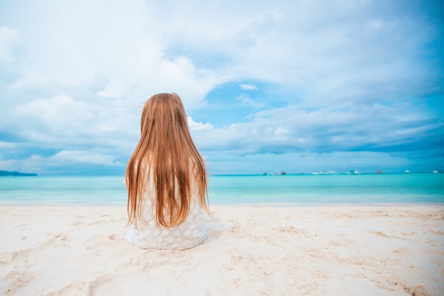 Entzückendes kleines Mädchen am Strand während der Sommerferien