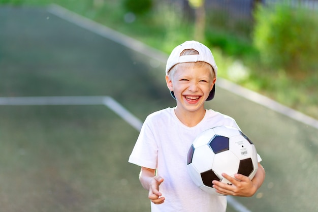 Entzückendes sportliches Kind auf dem Fußballplatz