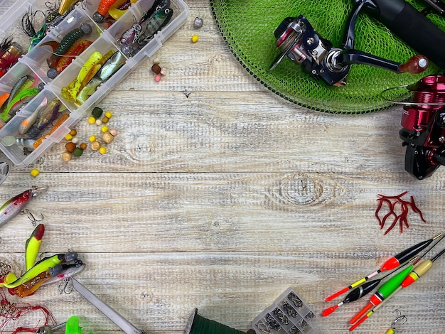 Foto equipamento de pesca. flutuador, wobbler, anzóis de isca, em um fundo de madeira. foco seletivo