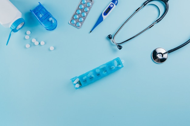Equipamento médico e pílulas em um azul