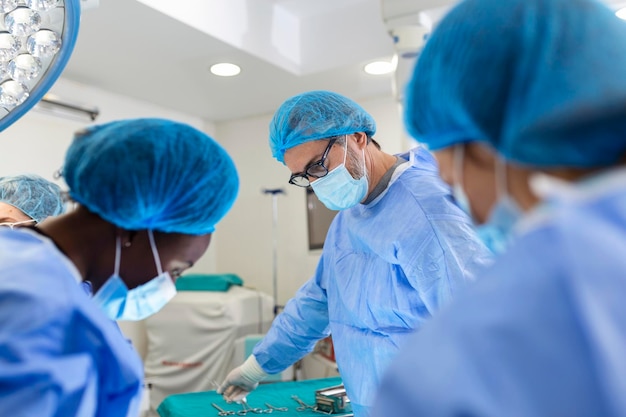 Equipe de cirurgiões de uniforme realiza uma operação em um paciente em uma clínica de cirurgia cardíaca Medicina moderna uma equipe profissional de saúde de cirurgiões