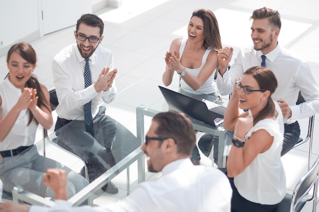 Equipe de negócios aplaude o gerente de projeto o conceito de trabalho em equipe