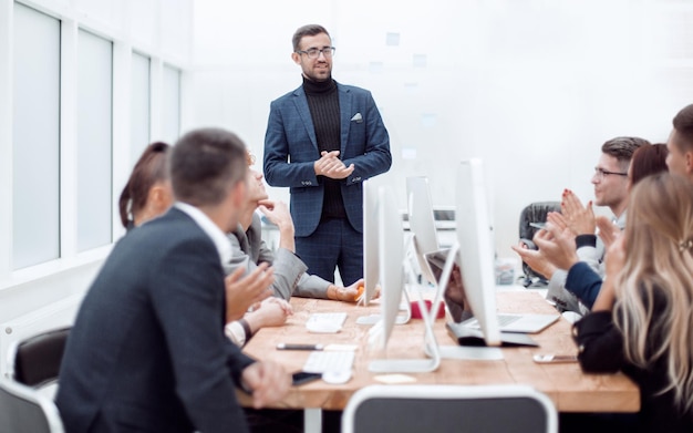 Equipe de negócios apoiando seu chefe com aplausos