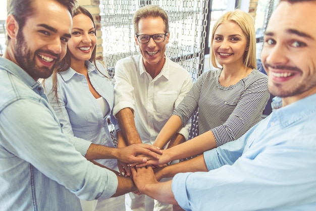 Equipe de negócios em roupas casuais é de mãos dadas juntos.